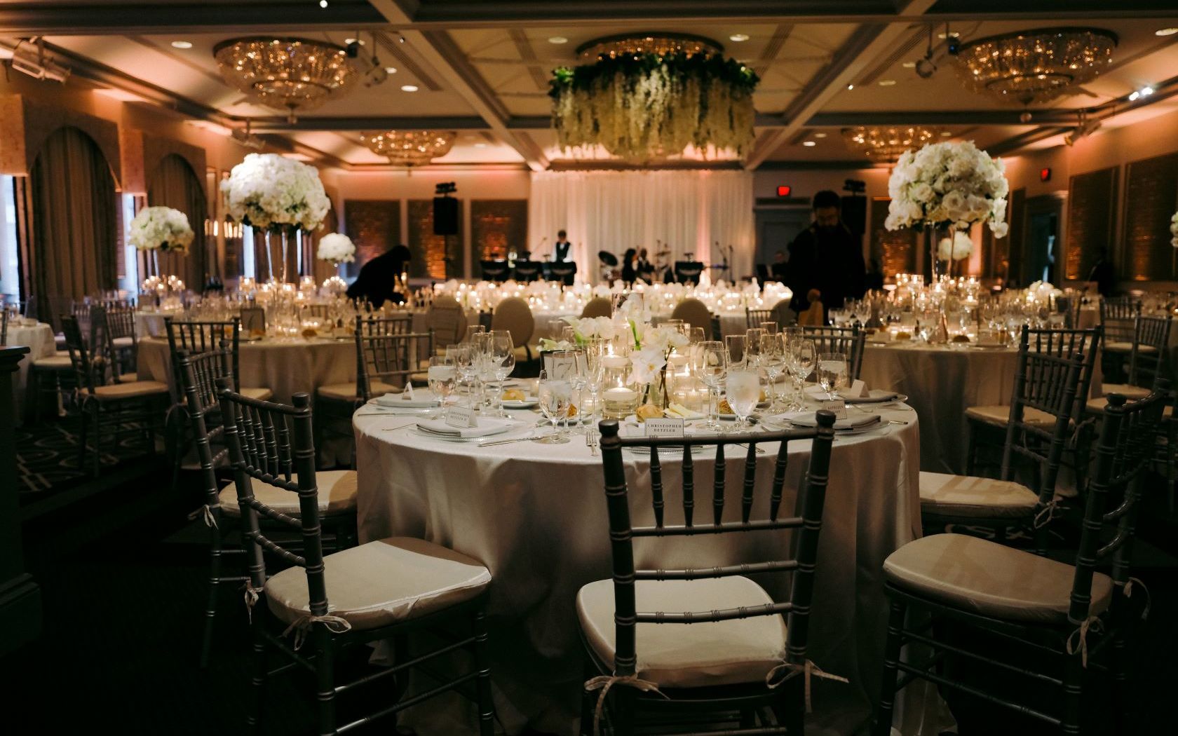 A Large Dining Room With Tables Set For A Formal Dinner